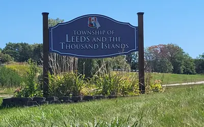 Township Road sign with Township logo centered on the top and the text beneath reads, Township of Leeds and the Thousand Islands
