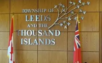 Council chambers with township logo and canadian and ontario flags